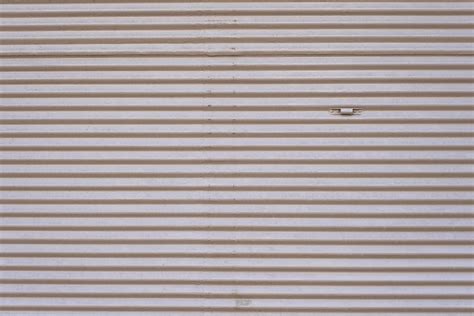 Grey vintage striped door, closeup of garage steel wall texture ...