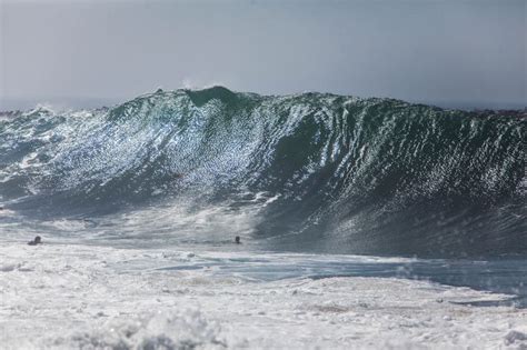 Surfers Tackle 20-Foot Waves While You Sit Inside Reading This