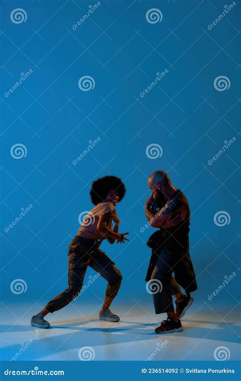 Couple Dancing Hip Hop on Blue Backdrop in Studio Stock Photo - Image ...