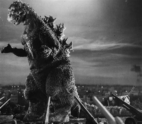 a godzilla standing in front of a city at night