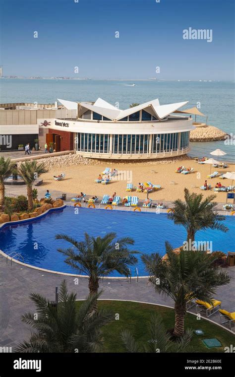 Qatar, Doha, West Bay, Beach and swimming pool of Hilton Hotel Stock ...