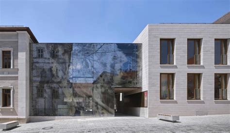 reiner john links historic building to extension with glass façade