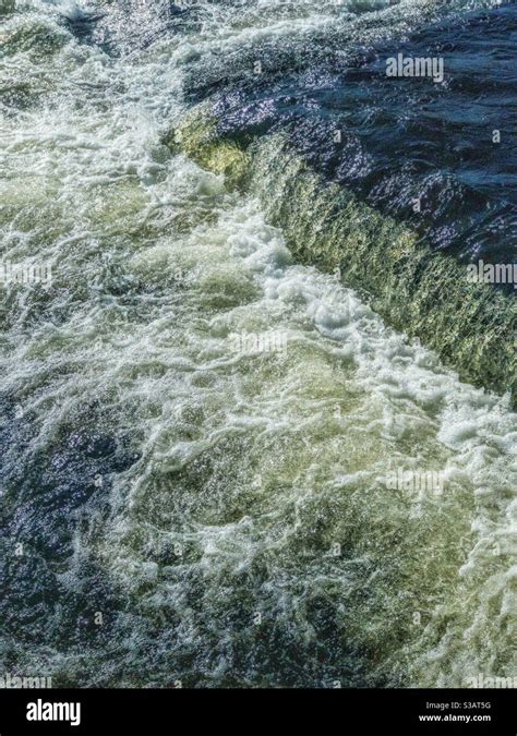 Turbulent water at river weir Stock Photo - Alamy