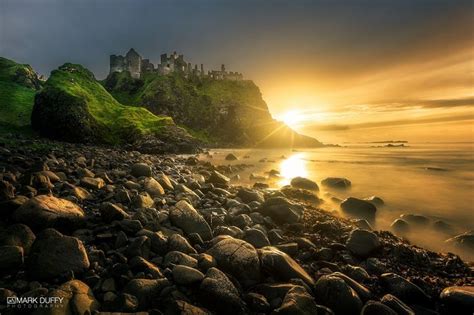 Dunluce Castle Sunset Standing strong over a cliff, battling the power ...