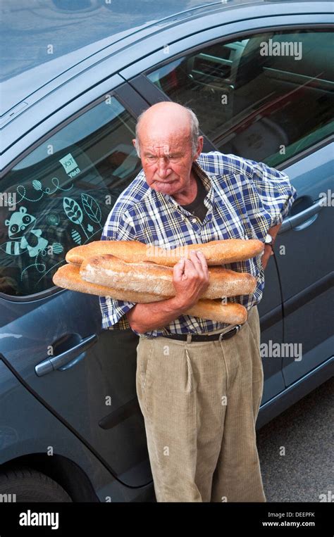 Frenchman holding his daily bread - France Stock Photo - Alamy