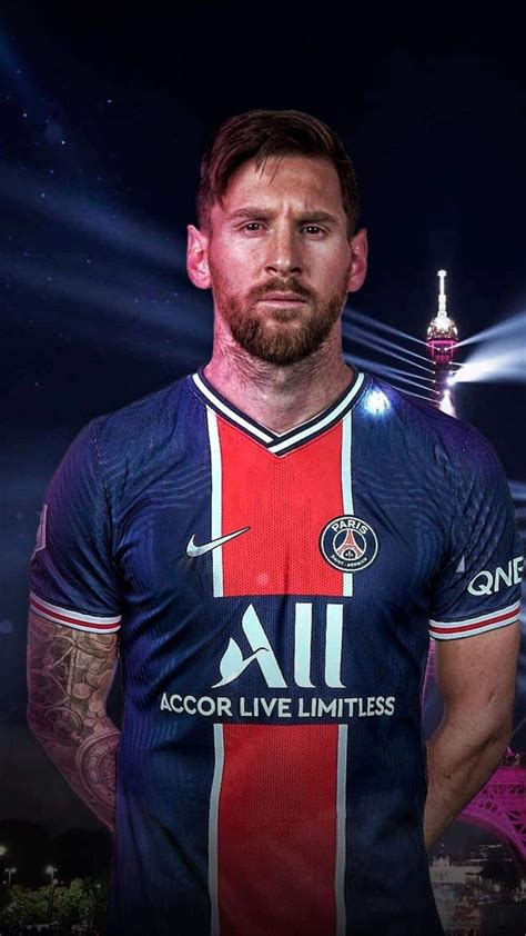 a man in a red and blue shirt standing next to the eiffel tower