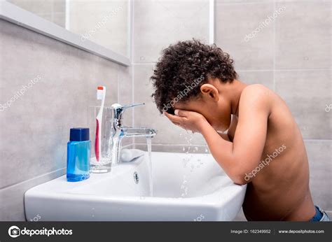 Little afro kid washing face Stock Photo by ©IgorTishenko 162349952