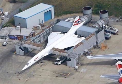 an aerial view of two airplanes parked in front of a factory