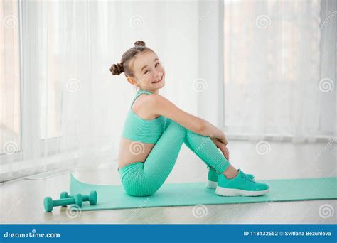 Little Sporty Girl Gymnast In Sportswear Doing Exercises On A Mat ...