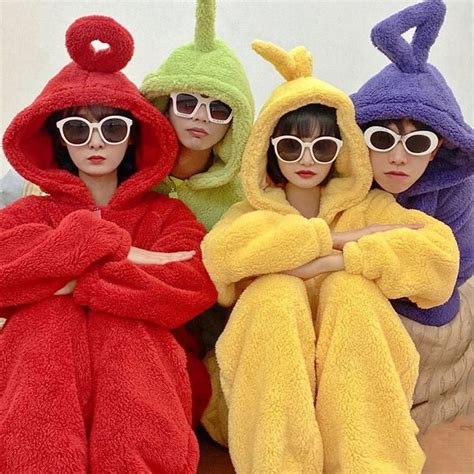 three women in bathrobes sitting on the floor