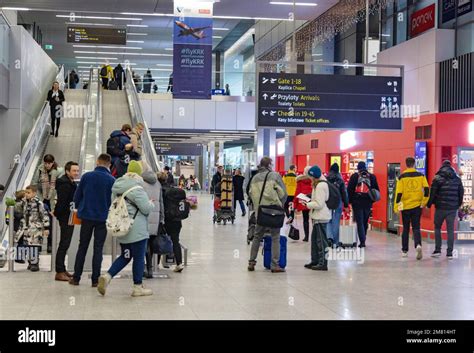 People in the terminal interior of Krakow Airport, aka. John Paul II ...