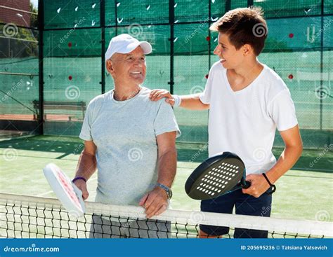 Padel Players of Different Generations Talking on Court Playing Paddle ...