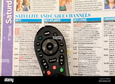 satellite television remote control and tv magazine england uk Stock ...