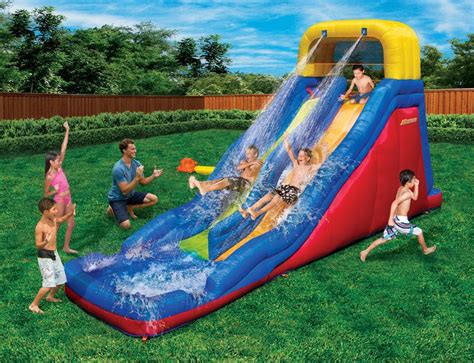 an inflatable water slide with kids playing on it