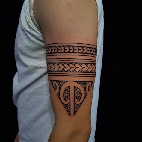 Maōri tattoo arm bands with a traditional Ta Moko triangle done ...