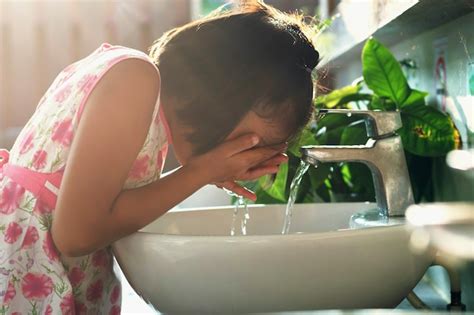 Premium Photo | Children washing face in basin