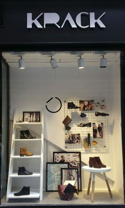 a store window with shoes and pictures on display