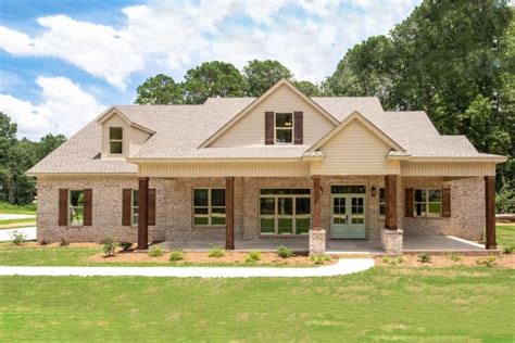 This single-story craftsman home plan features a traditional brick ...