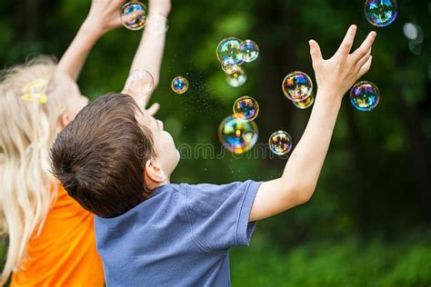 Kids blowing bubbles stock photo. Image of garden, leisure - 32357324