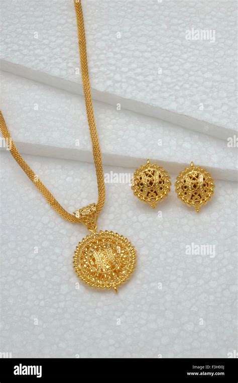 Gold jewellery pendant with earring set Stock Photo - Alamy