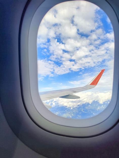 Premium Photo | Blue cloudy sky with the wing of the airplane seen ...