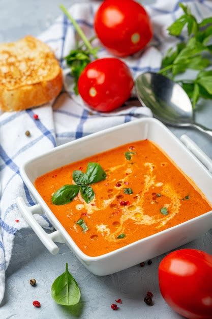 Premium Photo | Spicy tomato soup with green basil