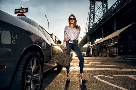 Beautiful fashion model woman posing with a car wearing casual s | 7Suns.no