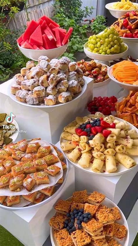 a table topped with lots of different types of desserts and pastries on ...