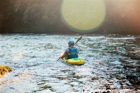 Man Kayaking Upstream, Paddling on the Turbulent River Stock Photo ...