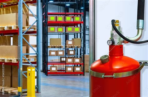 Fire safety equipment. Big red fire extinguisher inside warehouse ...