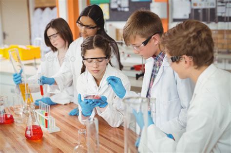 Attentive school kids doing a chemical experiment in laboratory Stock ...