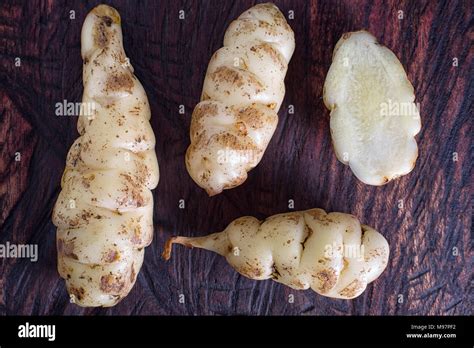 Oxalis tuberosa also known as oca tuber on rustic background Stock ...