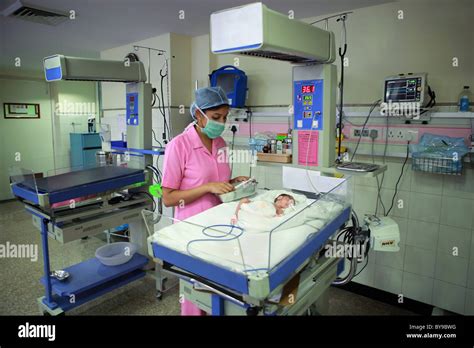 Nurse tending to newborn baby in hospital nursery Stock Photo - Alamy