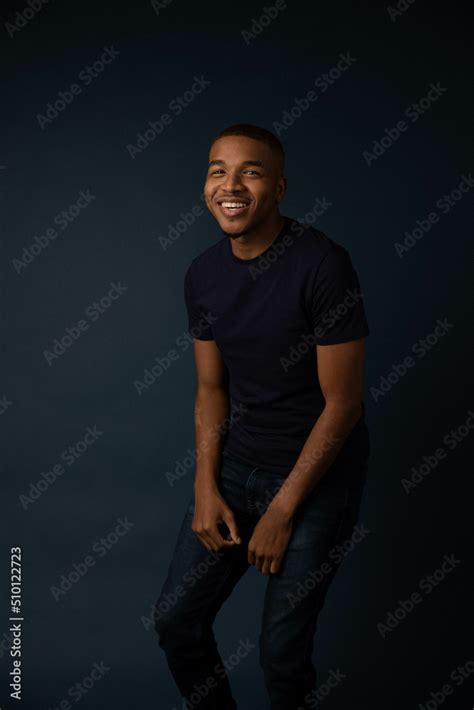 Black Man Smiles for Portrait On Navy Backdrop Stock Photo | Adobe Stock