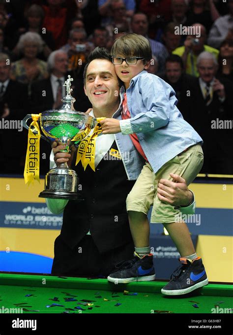 Ronnie O'Sullivan holds the trophy and his son Ronnie after winning the ...