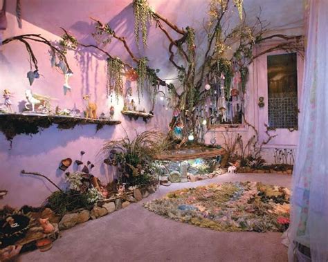 a living room filled with lots of plants and hanging decorations on the ...