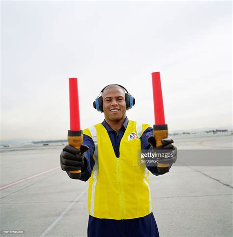 Airport Ground Crew Holding Signaling Sticks High-Res Stock Photo ...