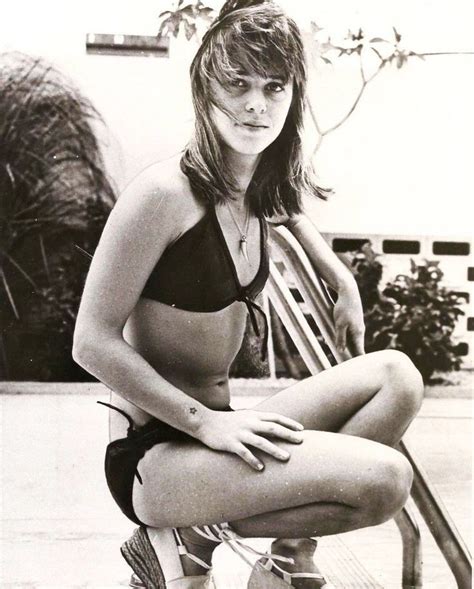 black and white photograph of a woman sitting on a chair in the pool ...