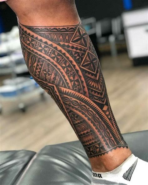 a man's leg with an intricate tattoo design on his arm and leg,