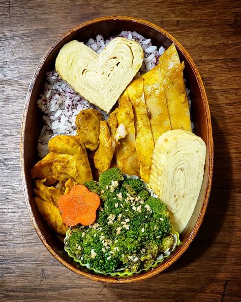 Heart tamagoyaki bento with curry baked chicken, sesame broccoli and ...