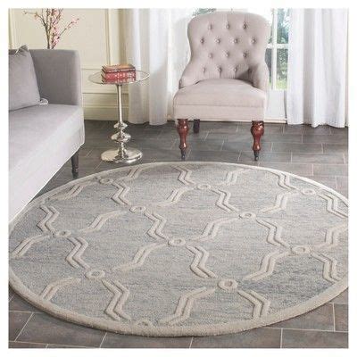 a living room with a chair and rug on the floor