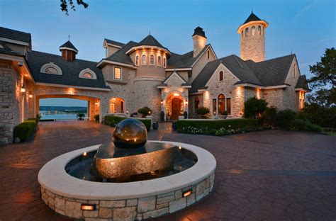 a large house with a fountain in front of it