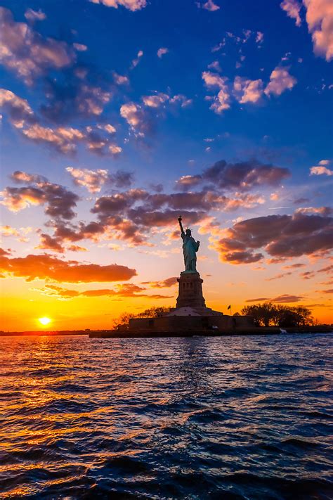 Statue of Liberty at sunset, New York Harbor, New York, New York USA ...