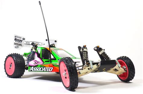 a remote controlled buggy is shown on a white surface with pink wheels ...