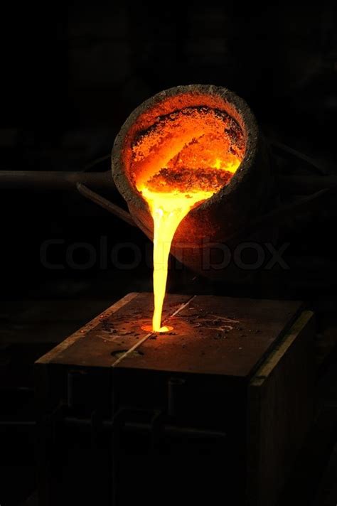 Foundry - molten metal poured from ... | Stock image | Colourbox