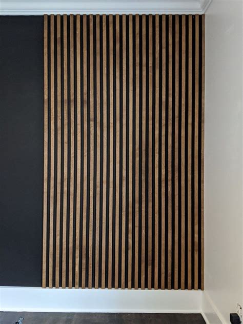 Stained-wood-slat-wall-installed-on-black-wall-progress | Wood slat ...