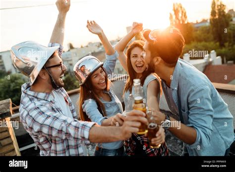 Group of happy friends having party on rooftop Stock Photo - Alamy