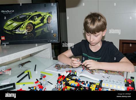 9 year old boy playing with Lego set Stock Photo - Alamy