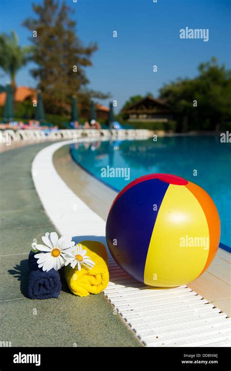 Beach ball at swimming pool Stock Photo - Alamy