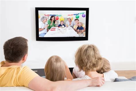 Young Family Watching TV Together — Stock Photo © AndreyPopov #55360421